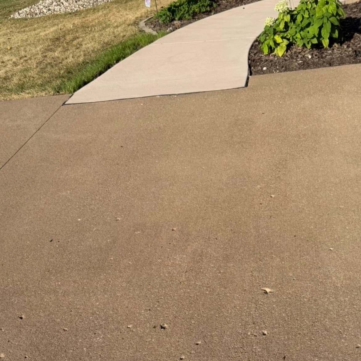 Clean concrete driveway after professional pressure washing in Bettendorf, IA