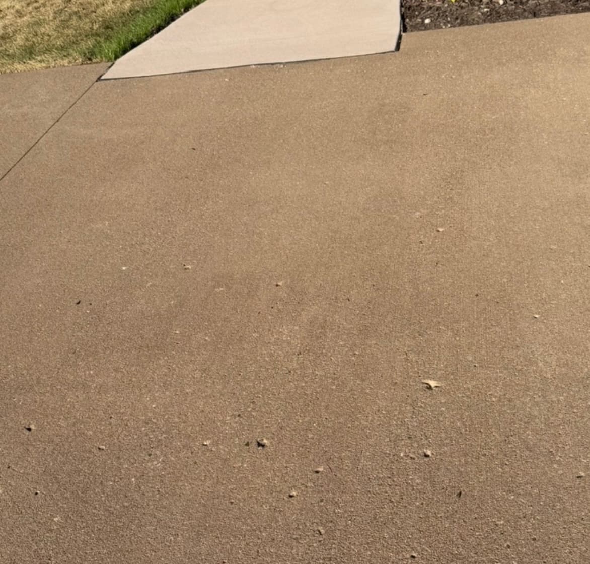 Clean concrete driveway after professional pressure washing service in Bettendorf, IA
