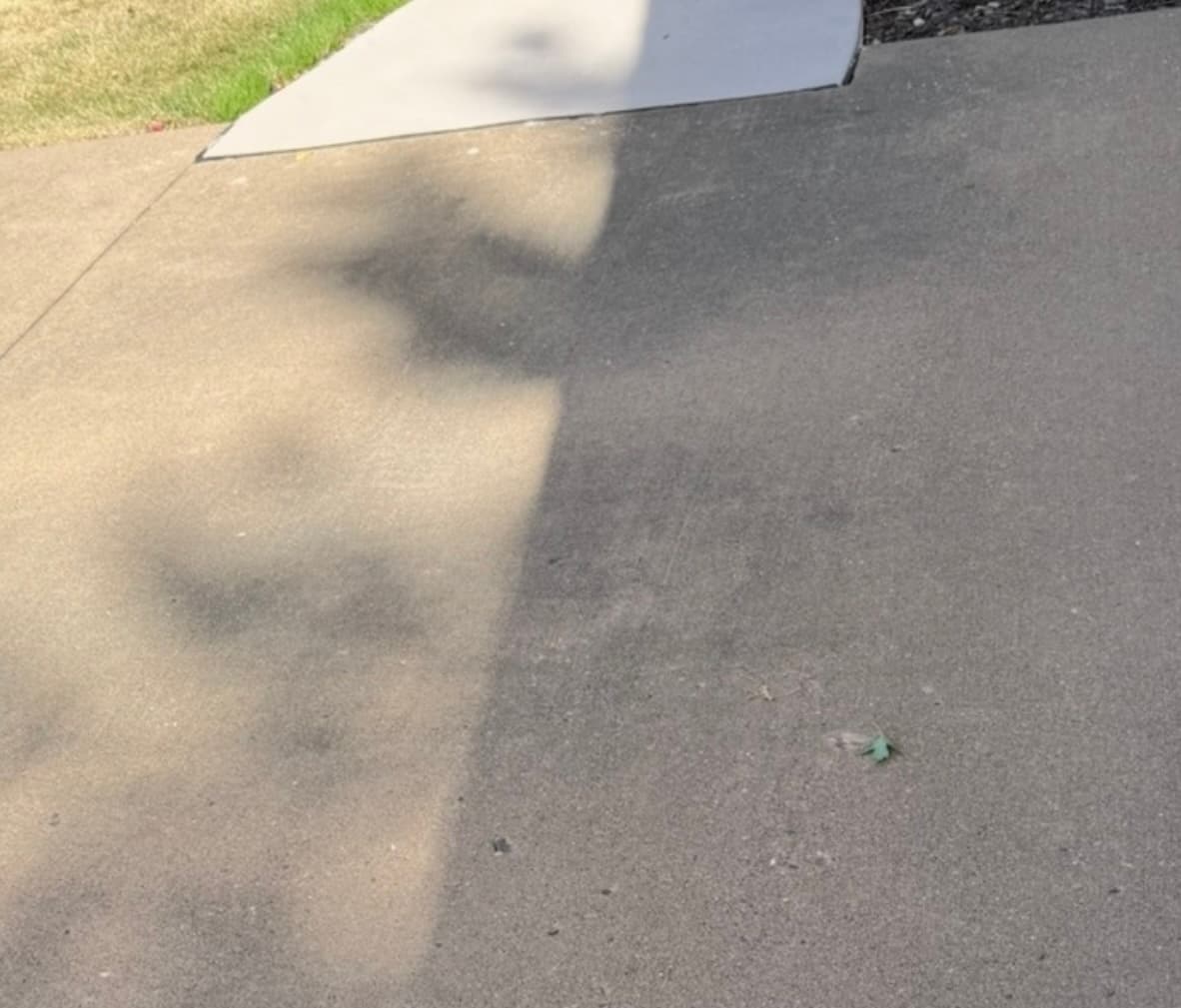 Dirty concrete driveway before professional pressure washing in Quad Cities, IA