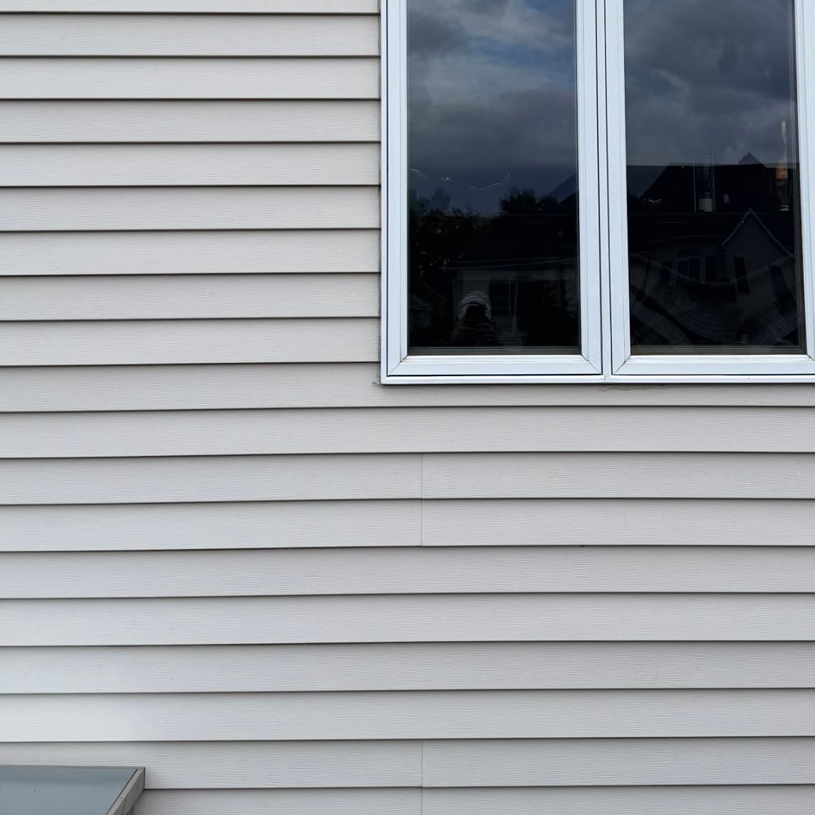 Clean vinyl siding after professional pressure washing in Quad Cities, IA